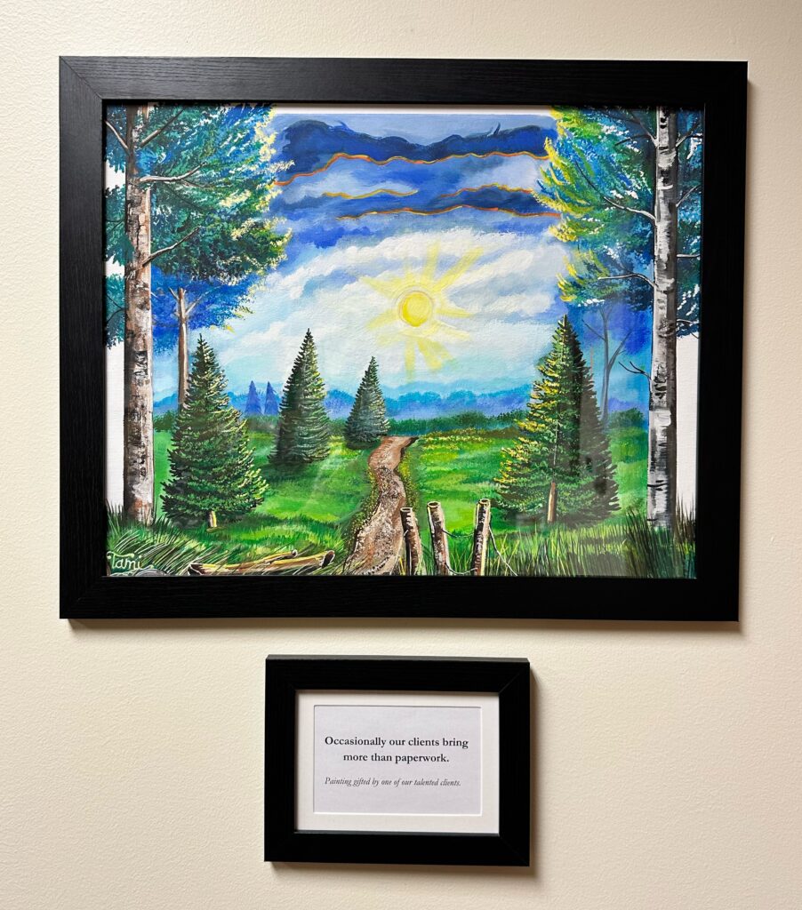 A vibrant landscape painting with a winding path, tall green trees, and a bright sun, accompanied by a plaque about client gifts.